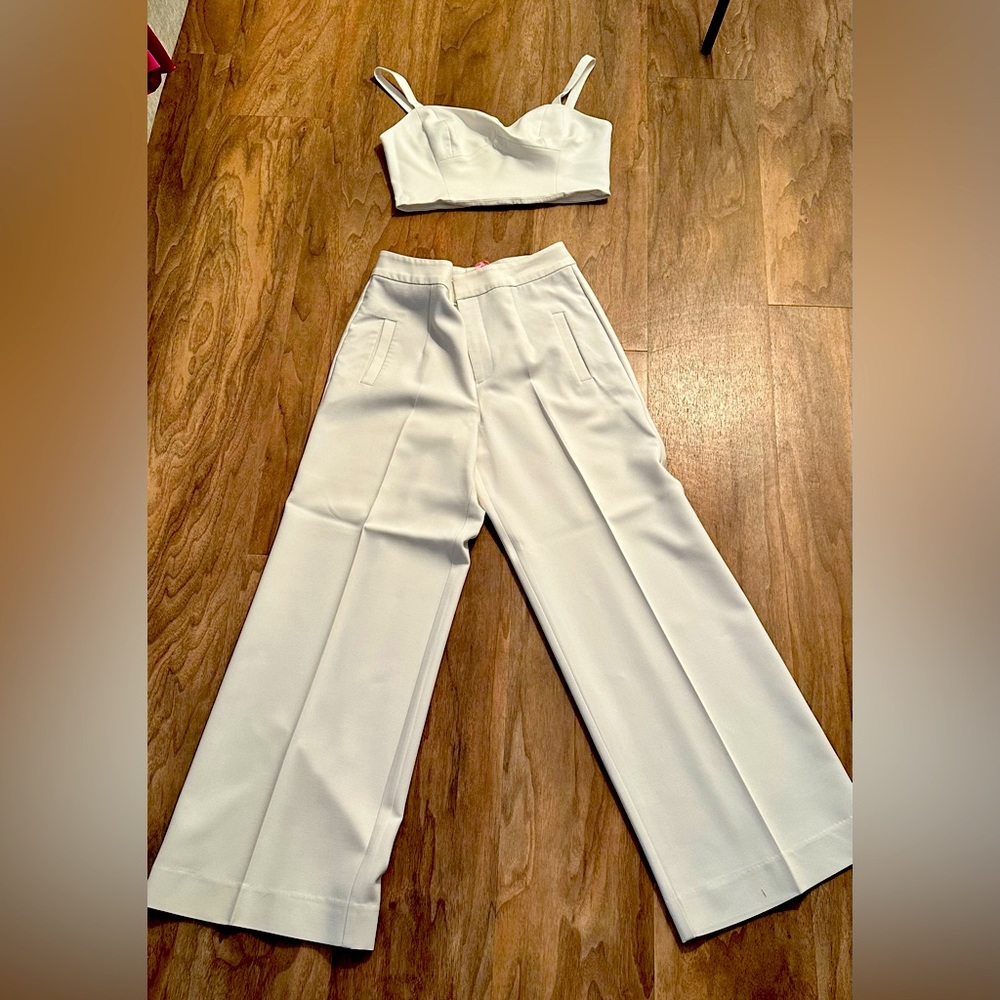 White set that includes crop top and high waisted tailored pants.